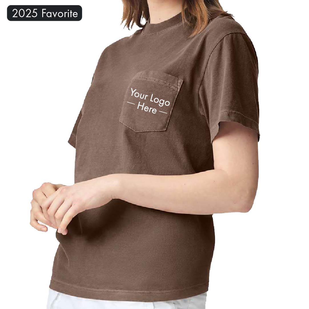 Comfort Colors 6030 pocket t-shirt in brown, shown with mockup logo on pocket and worn by female model