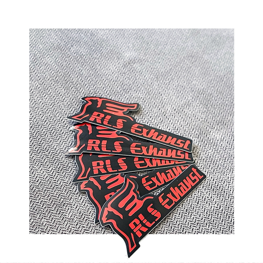 Custom RLS Exhaust logo stickers in black and red with a die-cut flame graphic, displayed on textured fabric