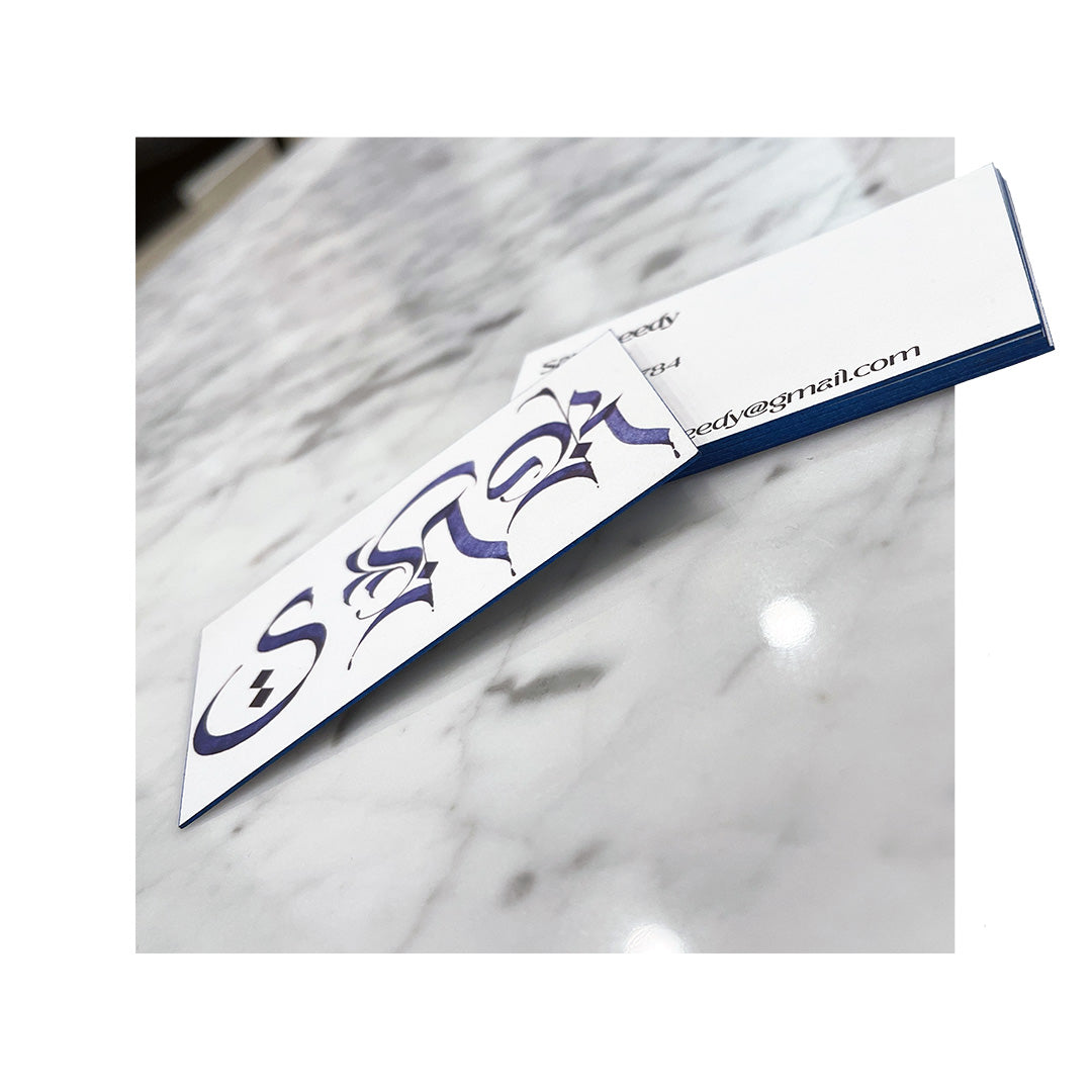 Unique business cards with artistic gothic lettering and bold blue painted edges