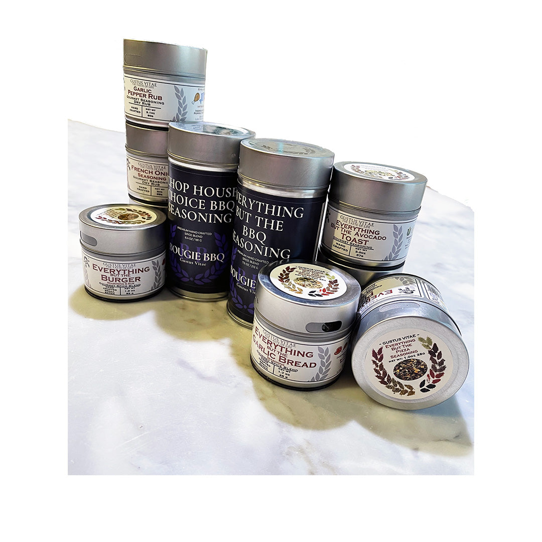 Assorted custom spice jar labels for gourmet seasonings on a marble surface