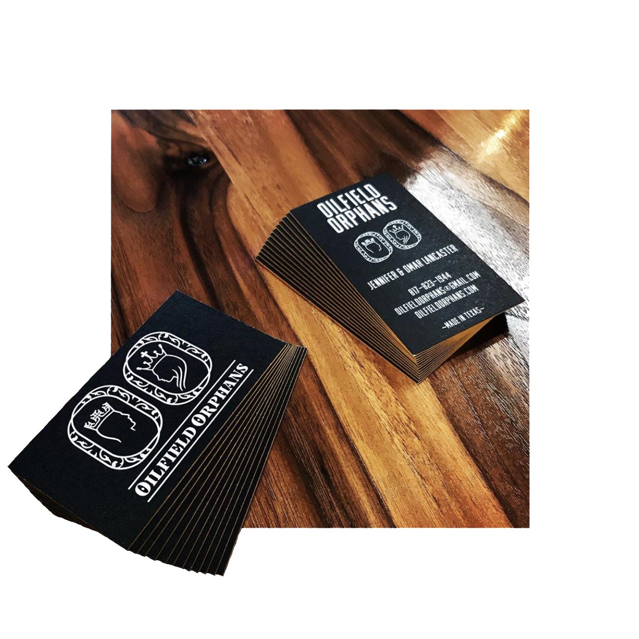 Sleek black business cards with metallic gold painted edges and white print