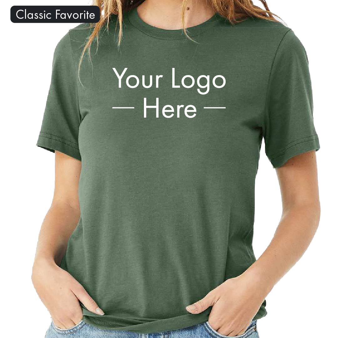Front view of a woman wearing a dark green Bella Canvas 3001 t-shirt with placeholder text reading "Your Logo Here"