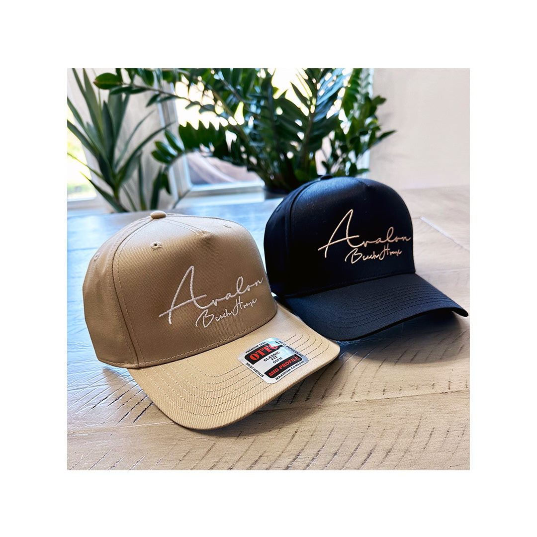 Custom embroidered OttoCap 31-069 hats for Avalon Beach House in tan and black colorways