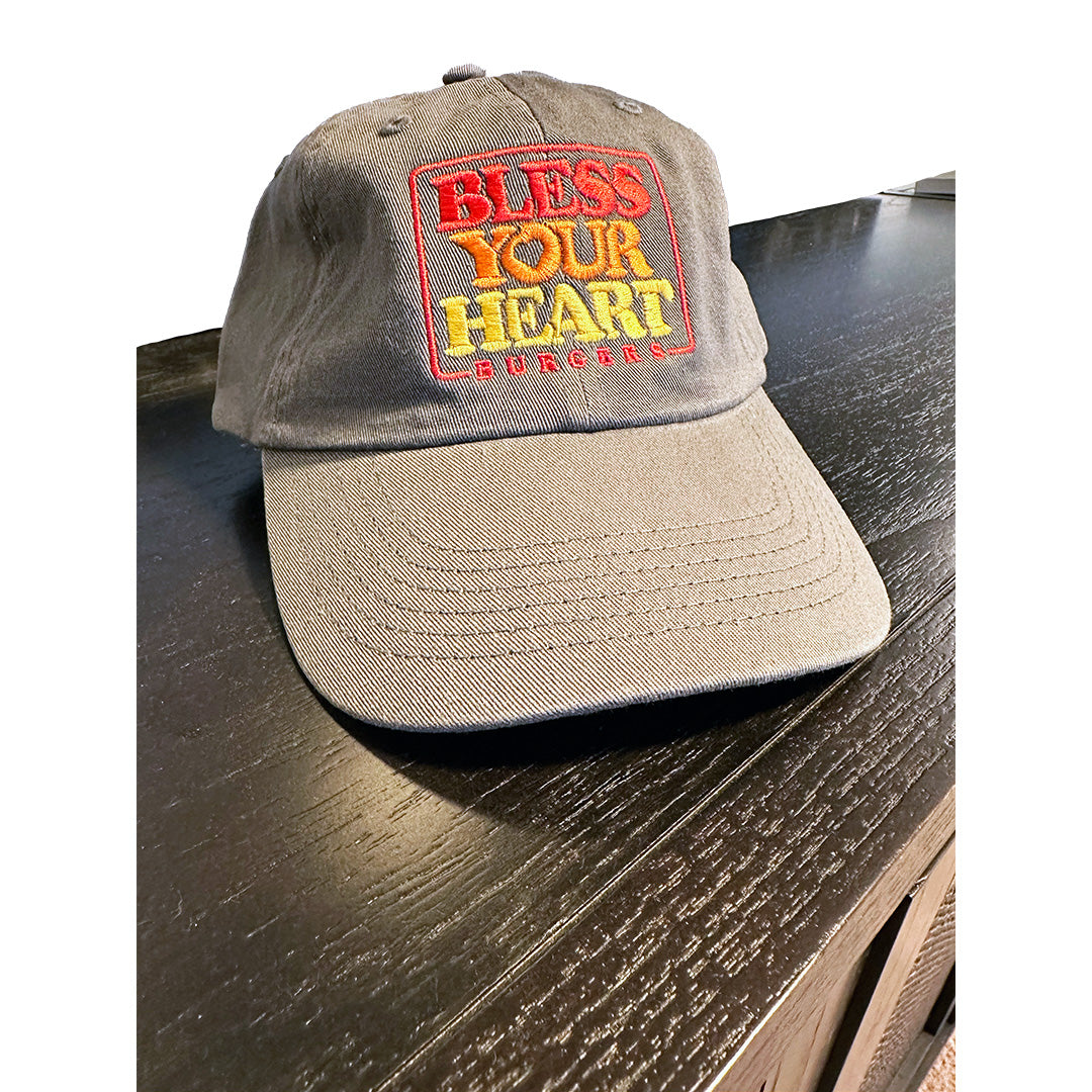 Custom embroidered "Bless Your Heart Burgers" dad hat on dark wood surface – Valucap VC300a