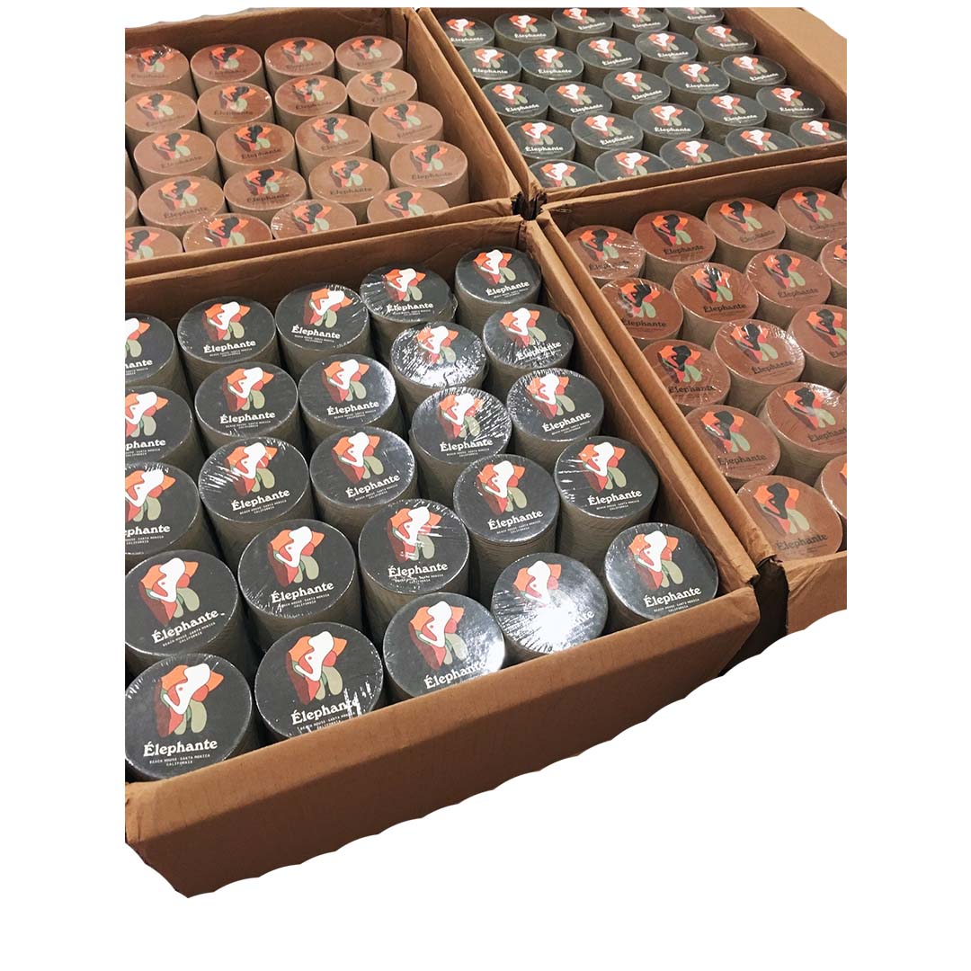 Bulk order of round coasters with colorful Elephante logo, neatly packed in cardboard boxes for shipping