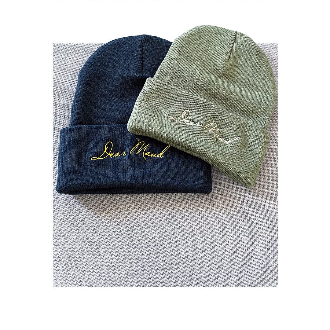Black and olive green Sportsman SP12 beanies featuring elegant script embroidery for Dear Maud