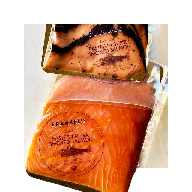 Custom clear circle labels on vacuum-sealed smoked salmon packaging for Frankel’s Deli, featuring black, navy, and white print for product branding