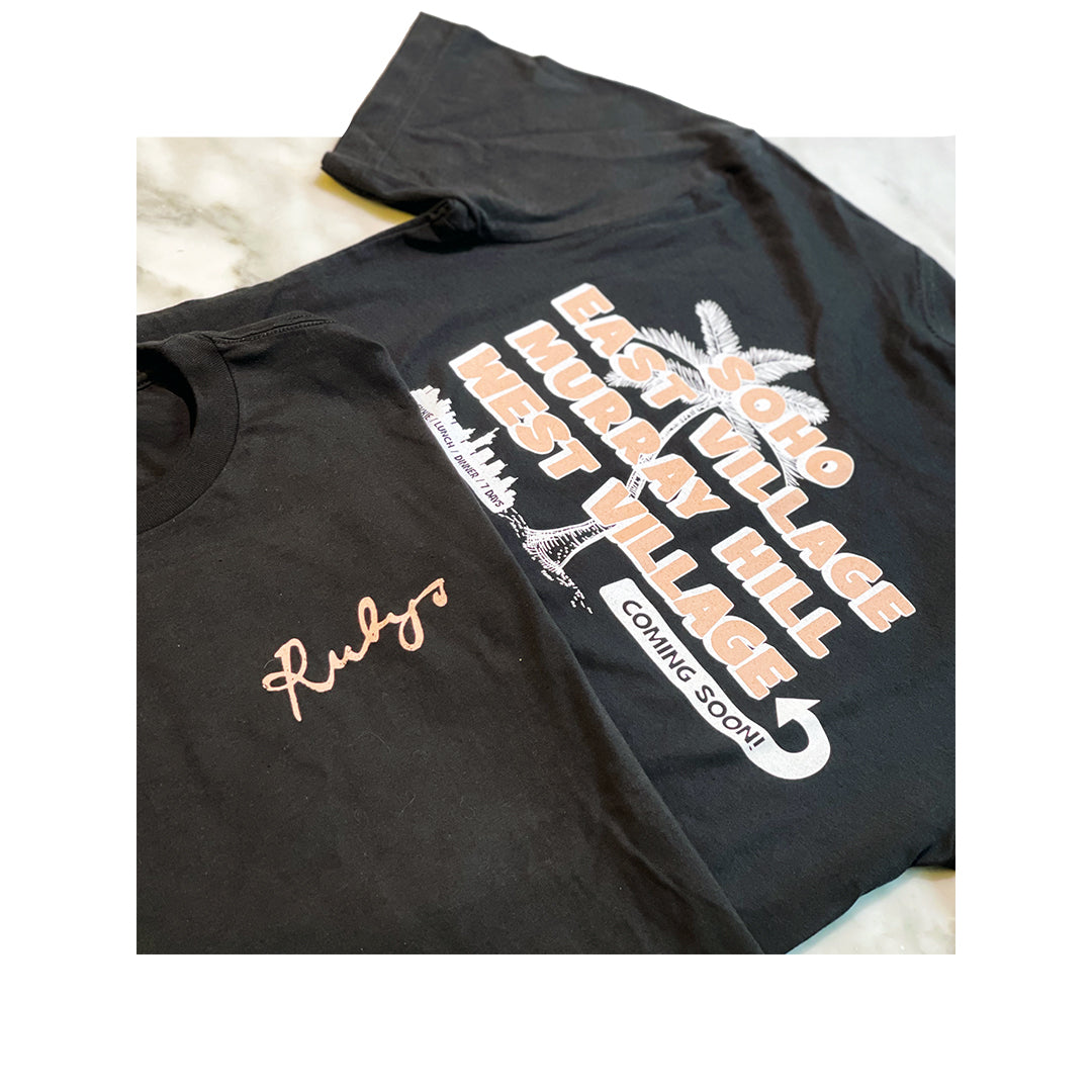 Black Bella Canvas t-shirts with Rubys logo embroidery on the front and a large New York City neighborhood graphic on the back, styled on a marble background