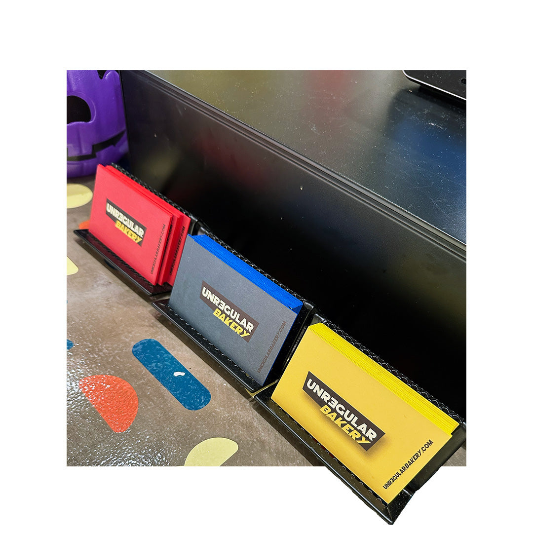 Vibrant business cards with colored fronts and matching painted edges for Unregular Bakery