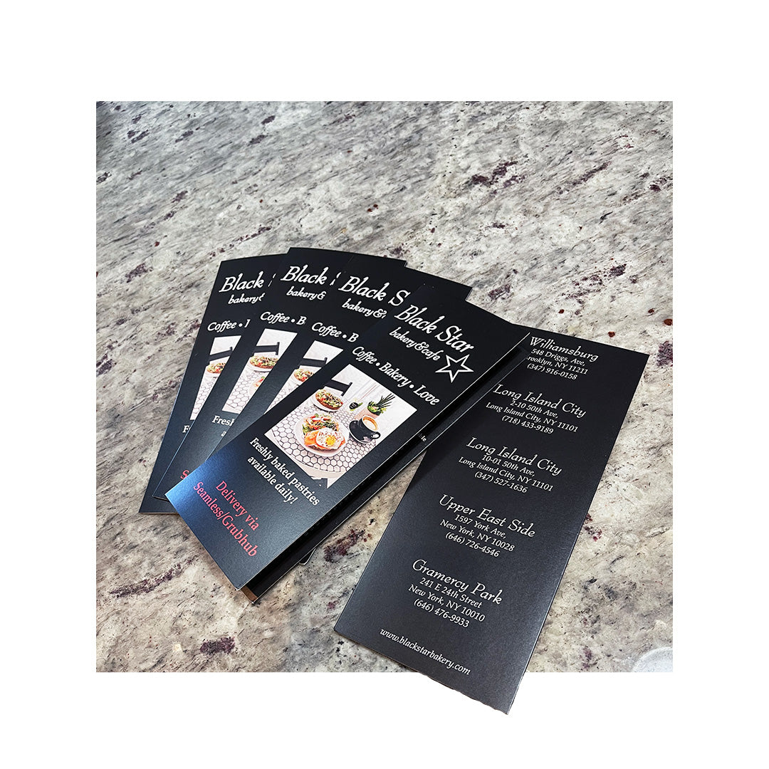 Folded takeout menus for Black Star Bakery with bold black design and location details