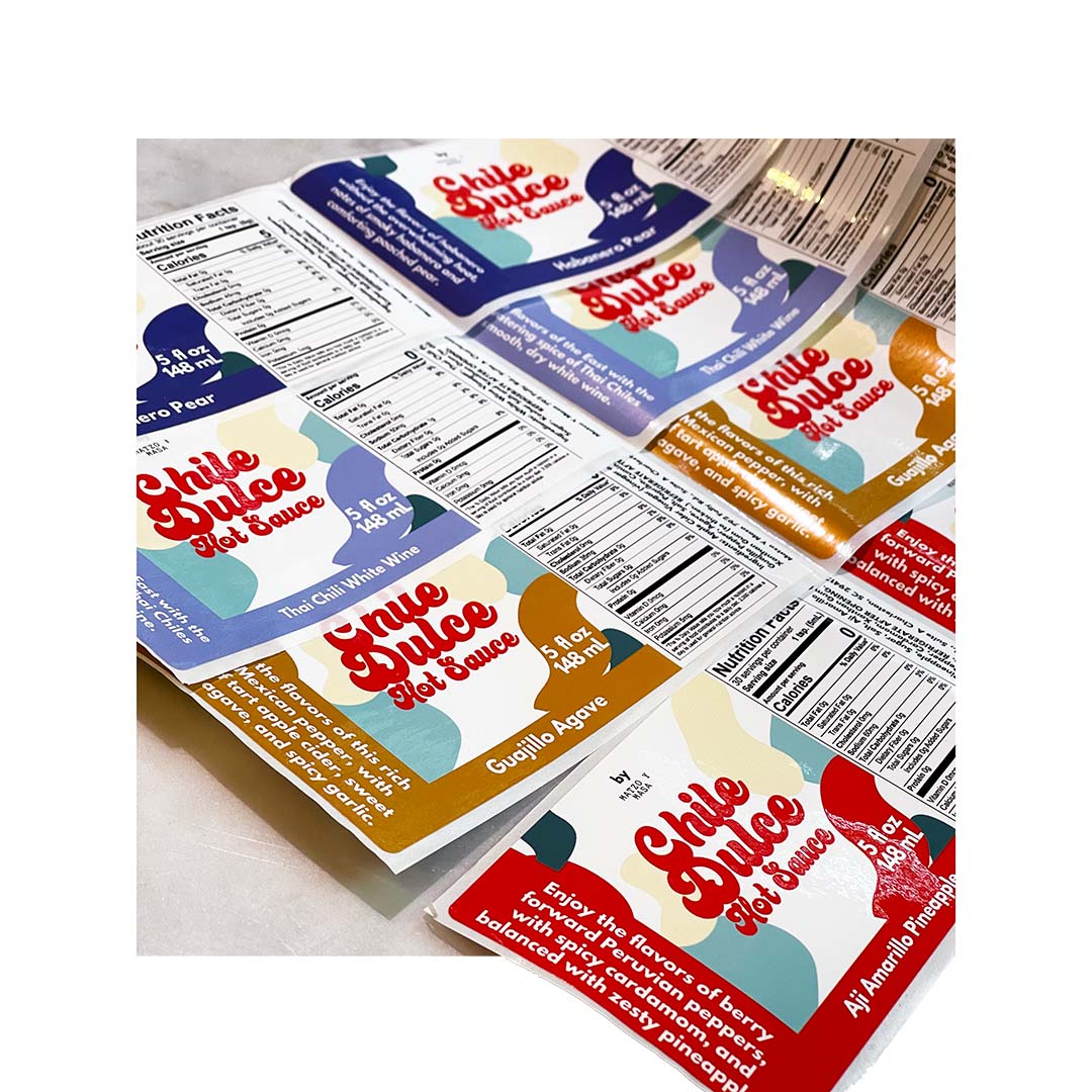 Colorful custom labels for Chile Dulce hot sauce in assorted flavors
