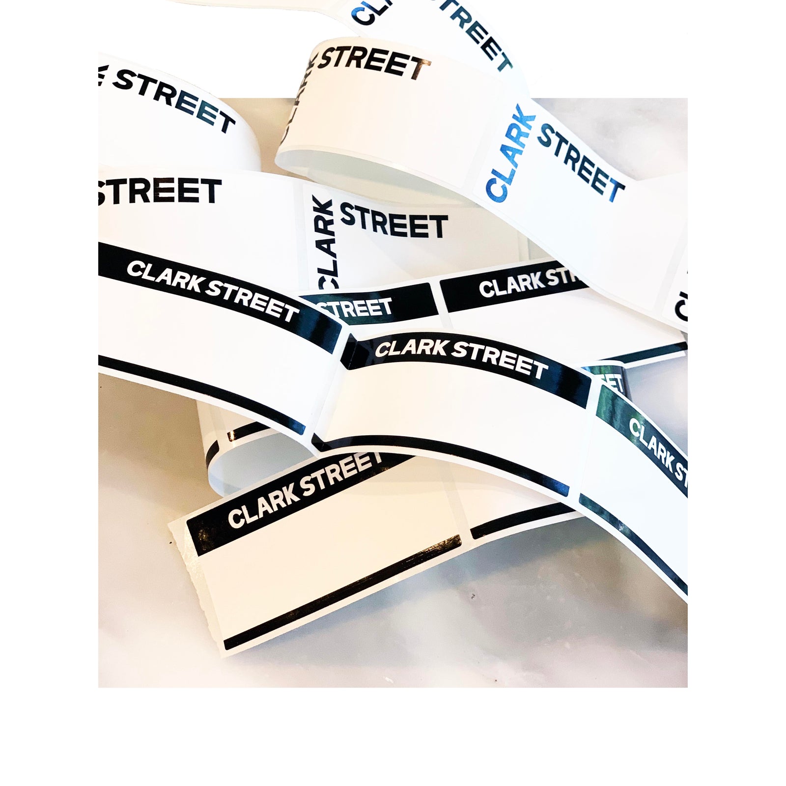 Custom rectangle labels for Clark Street Bakery, printed on white BOPP with bold black and blue branding in two design variations