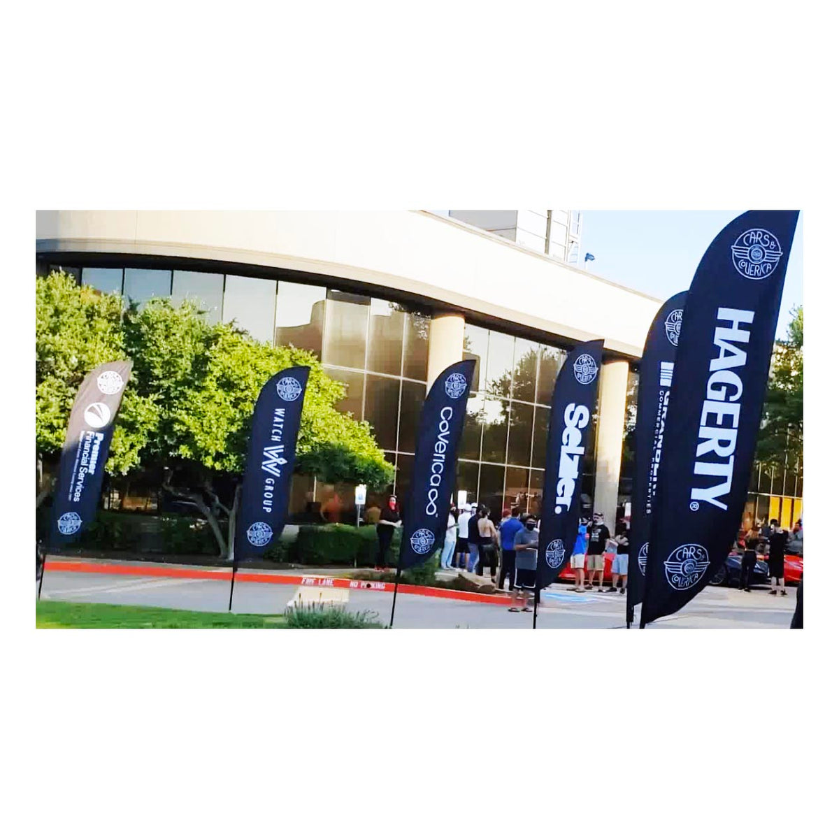 Series of custom feather flags at a corporate event, featuring clean branding for multiple sponsors