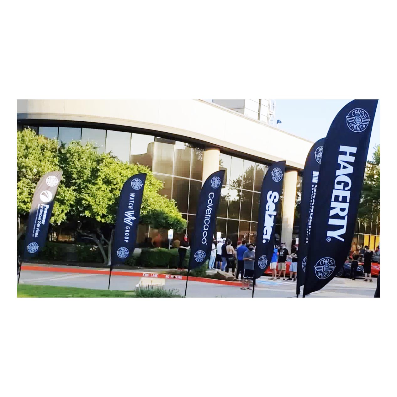 Series of custom feather flags at a corporate event, featuring clean branding for multiple sponsors
