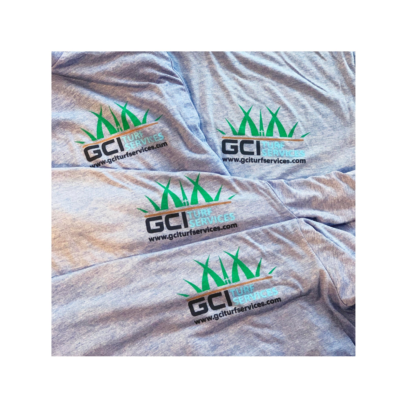 Four light gray Bella Canvas 3413 shirts with GCI Turf Services logo printed on the front in green and black, displayed flat in a grid format