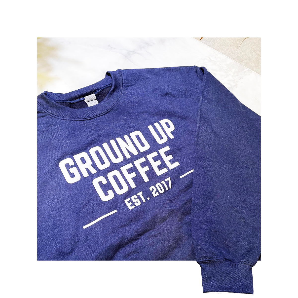 Custom printed navy blue Gildan sweatshirt with bold white “Ground Up Coffee Est. 2017” logo