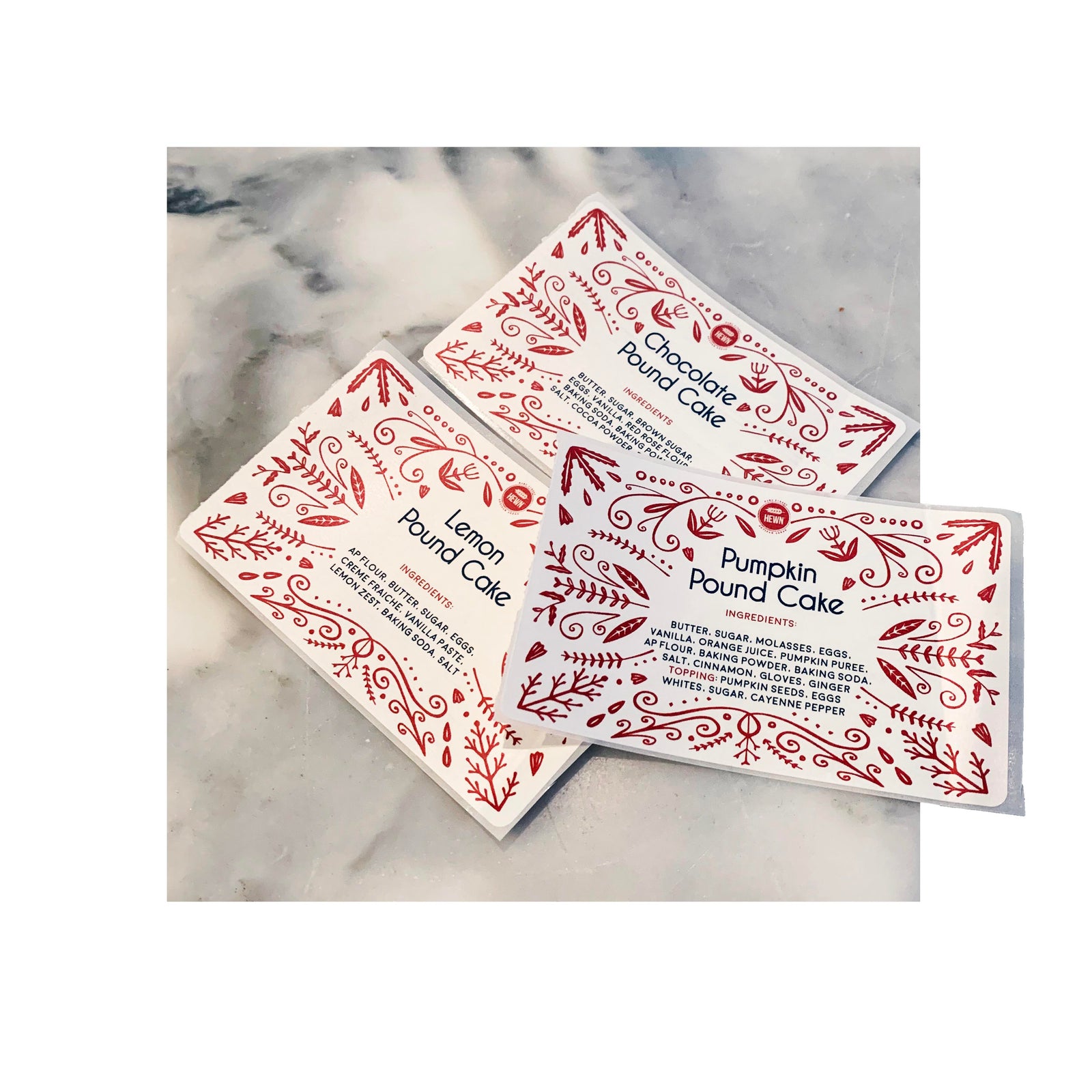 Custom rectangle labels with red folk art border for assorted pound cake flavors, designed for artisan bakery product packaging