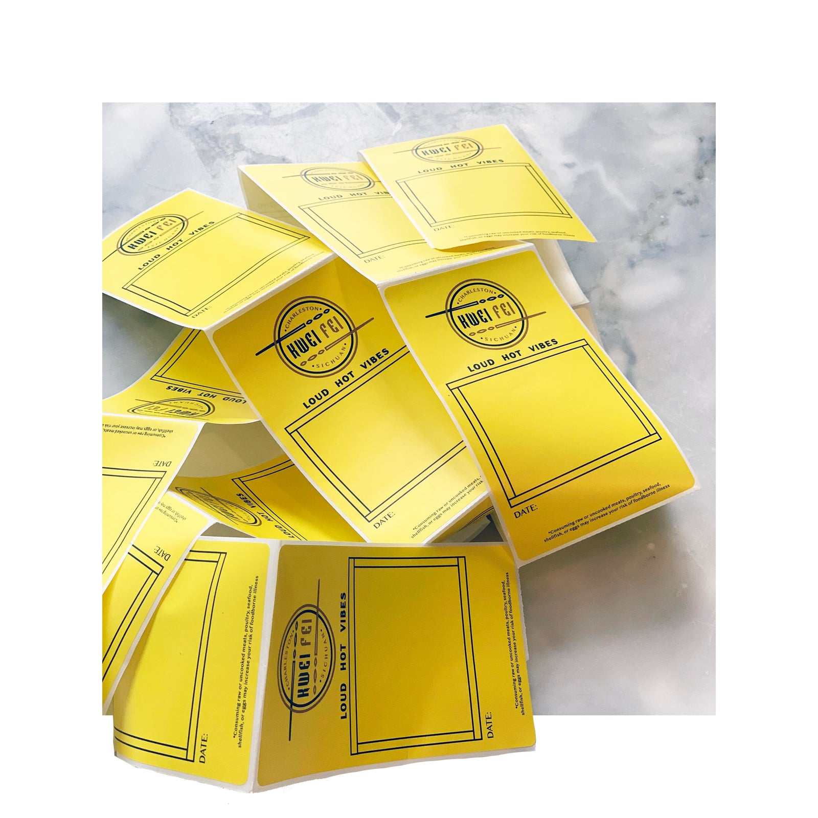 Roll of bright yellow rectangle labels for Huge Feels, designed with writable space and bold black border for product dating or custom notes