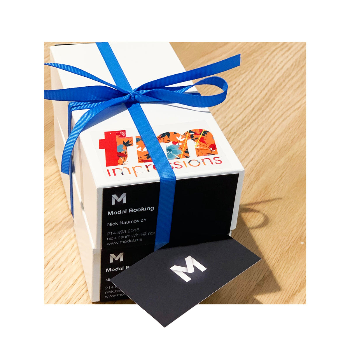 Branded box of suede business cards with spot gloss logo, ribbon tied for delivery presentation